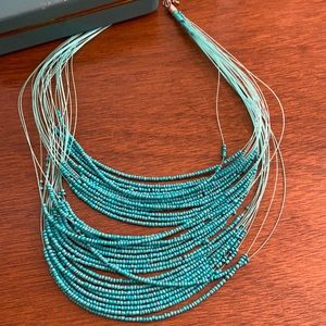 Teal/aqua colored beaded necklace. NWOT